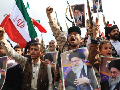 Houthi supporters hold posters of Iranian Supreme Leader Ayatollah Ali Khamenei and Irania