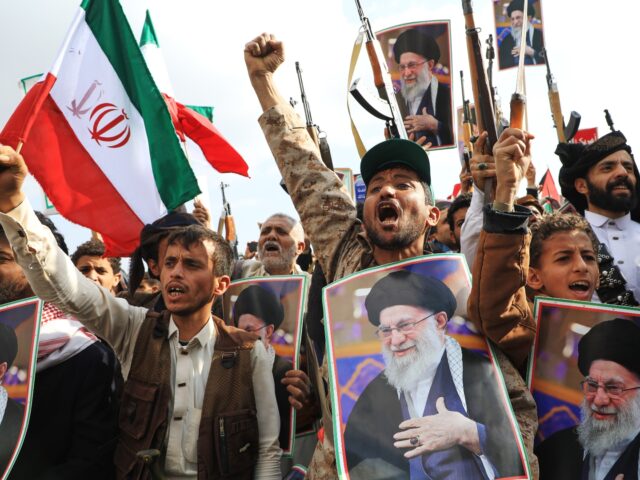 Houthi supporters hold posters of Iranian Supreme Leader Ayatollah Ali Khamenei and Irania