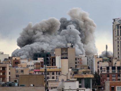 A plume of smoke rises after a strike in Tehran, Iran, Monday, March 2, 2026. (AP Photo/Mo