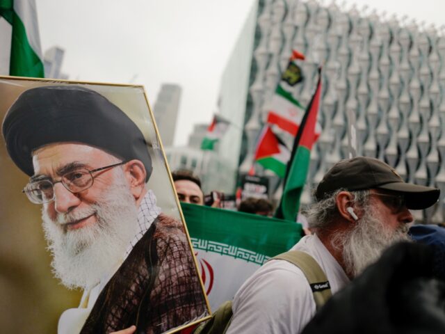 Demonstrators hold a photograph of Iran's late Supreme leader Ayatollah Ali Khamenei again