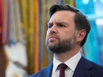 Vice President JD Vance listens as President Donald Trump speaks before signing an executi