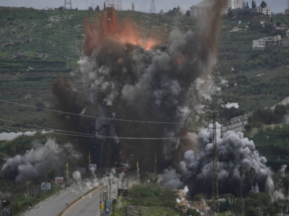 Smoke and flames rise from an Israeli airstrike that hit the Qasmiyeh Bridge near the coas