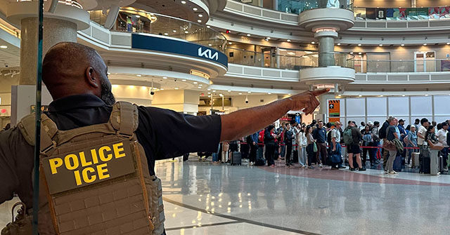 Title: Travel Delays Image ID: 26082459736115 Article: A federal immigration agent is seen as people wait in a TSA line at the Hartsfield-Jackson Atlanta International Airport, Monday, March 23, 2026, in Atlanta. (AP Photo/Emilie Megnien)