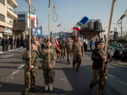 Young boys in military uniforms, as members of the Basij paramilitary force under the comm