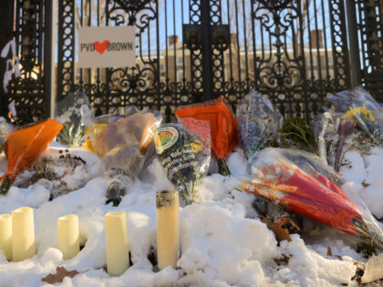 A memorial still stands outside a gate to campus as Brown University began classes for the