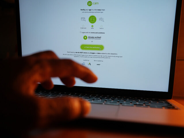 An online adult website asks to verify the age of the user on a laptop in London, part of