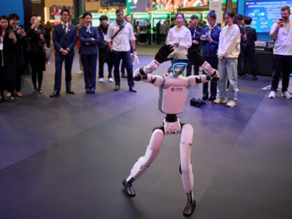 A robot produced by China Mobile dances to the beat of the music at the Mobile World Congr