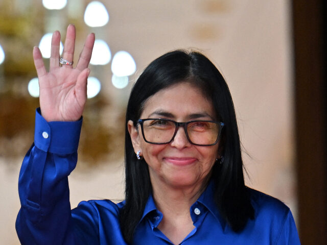 Venezuela's interim President Delcy Rodriguez waves after a press conference at the Mirafl