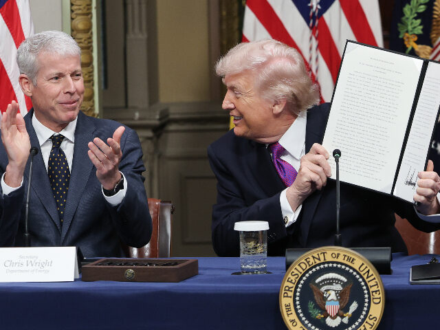 President Donald Trump holds up the Ratepayer Protection Pledge as U.S. Energy Secretary C