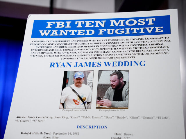 A FBI Ten Most Wanted Fugitive poster is displayed during a news conference announcing the