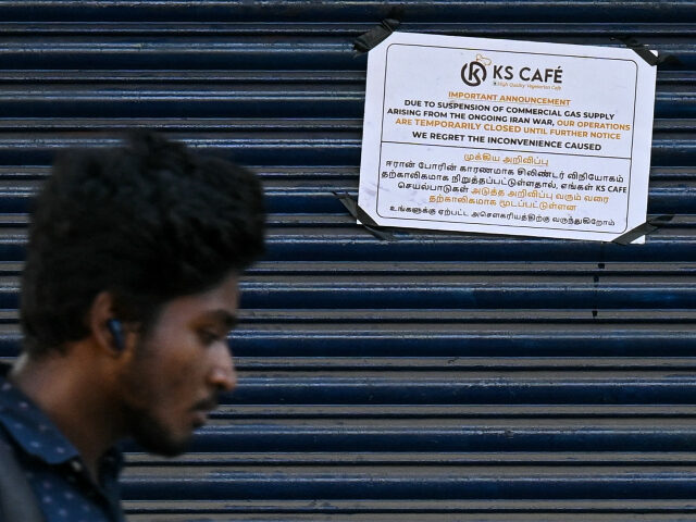 A man walks past a closed restaurant due to a shortage of commercial liquefied petroleum g