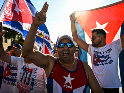 People shout slogans as they march through the streets of Miami, Florida, to commemorate l