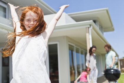 Smiling girl cheering in backyard