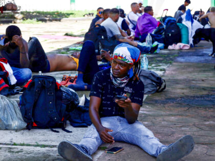 Migrants traveling in a caravan seeking to reach the Mexican capital on foot rest in Tapac