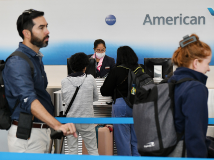Passengers check in at an American Airlines' counter at Ronald Reagan Washington National