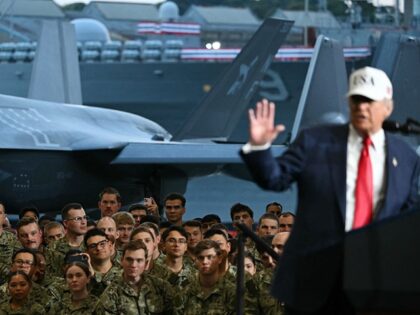 US President Donald Trump delivers a speech in front of US Navy personnel on board the US