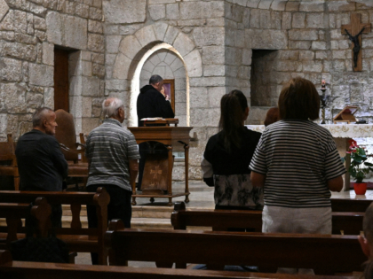Pilgrims attend a mass at the Maronite monastery of Saint Maron, which houses the shrine o