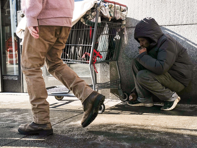 NEW YORK, NEW YORK - FEBRUARY 04: A person carrying their belongings pauses in the street