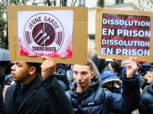 Young men holding placards Young terrorist guard Young guard dissolution Raphael Arnault i