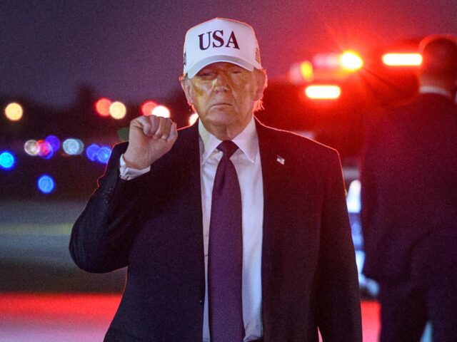 TOPSHOT - US President Donald Trump gestures as he arrives at Palm Beach International Air