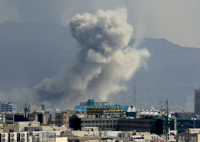 A plume of smoke acends after a military strike on the capital Tehran on March 2, 2026. Th