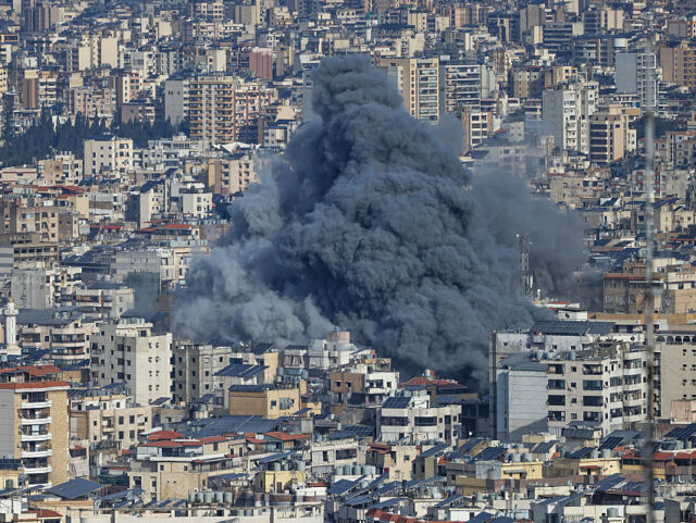 A plume of smoke rises from the site of an Israeli airstrike in the southern suburbs of Be
