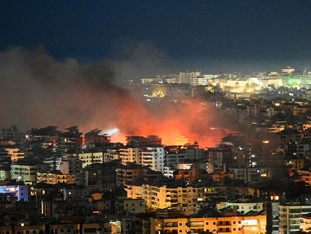 TOPSHOT - Fire rises from the site of an Israeli airstrike in the southern suburbs of Beir