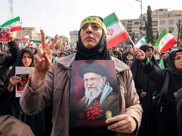 IRAN-US-ISRAEL-WAR A demonstrator holds a picture of Iran's late supreme leader Ayatollah Ali Khamenei d