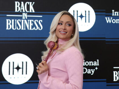 US socialite Paris Hilton poses before ringing the closing bell on the floor of the New Yo