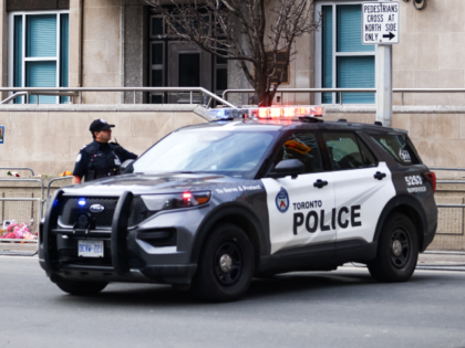 Toronto Police officers work around the scene of a shooting at the US Consulate in Toronto