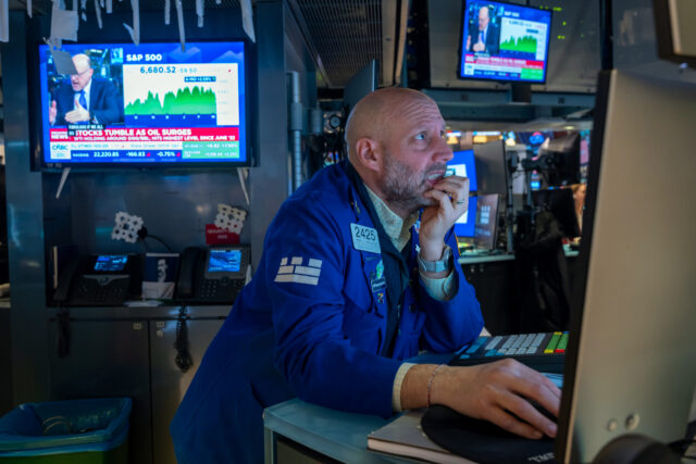 NEW YORK, NEW YORK - MARCH 09: Traders work on the floor of the New York Stock Exchange (N