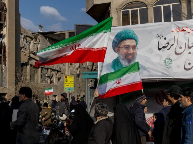 TEHRAN, IRAN - MARCH 9: Demonstrators gather with Iranian national flags for a rally in su
