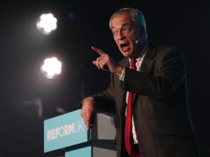 Reform UK leader Nigel Farage speaking on stage during a Reform UK rally at Mecca in Swind
