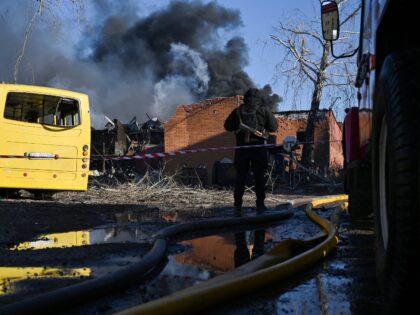 A policeman stands at a site of a strike in the town of Brovary, near Kyiv, following a Ru