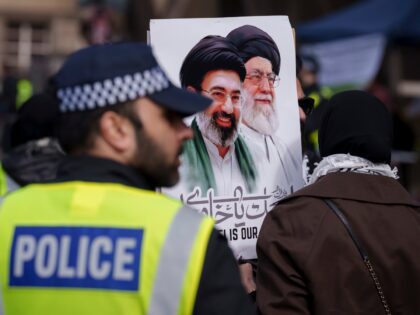 As the war on Iran and the Gulf states enters its third week, Met police officers watch pr
