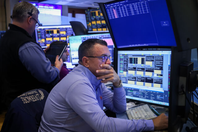 Traders work on the floor at the New York Stock Exchange (NYSE) in New York, US, on Monday