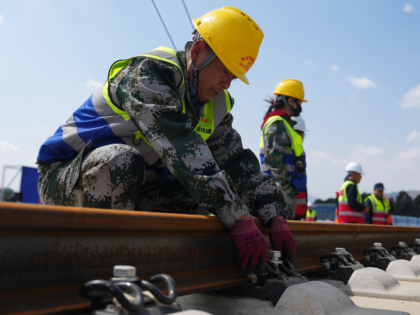 KUNMING, CHINA - MARCH 18: Workers carry out the track-laying operation at the constructio