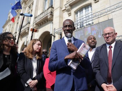 Saint-Denis' mayor Bally Bagayoko (C) addresses supporters next to Saint-Denis' city counc
