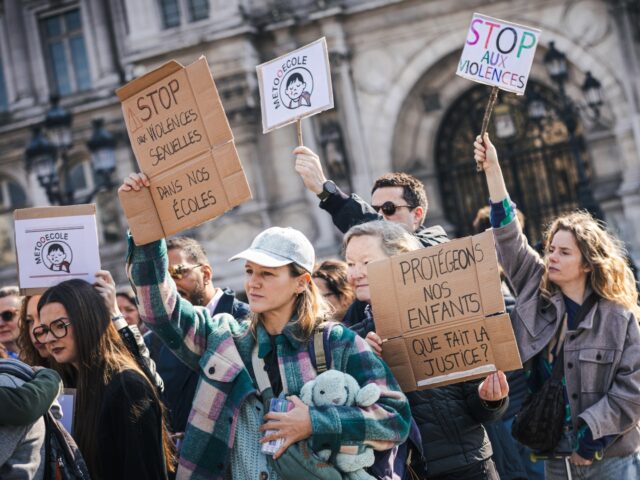 Protesters are holding placards bearing the slogans 'Stop sexual violence in our schools',