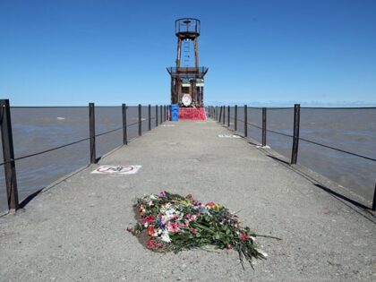 Flowers lie on the pier at Tobey Prinz Beach in Chicago on March 23, 2026, near where Sher