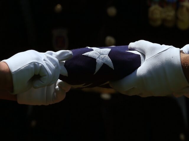 ARLINGTON, VA - JUNE 08: Members of a U.S. Army burial team fold the American flag that co