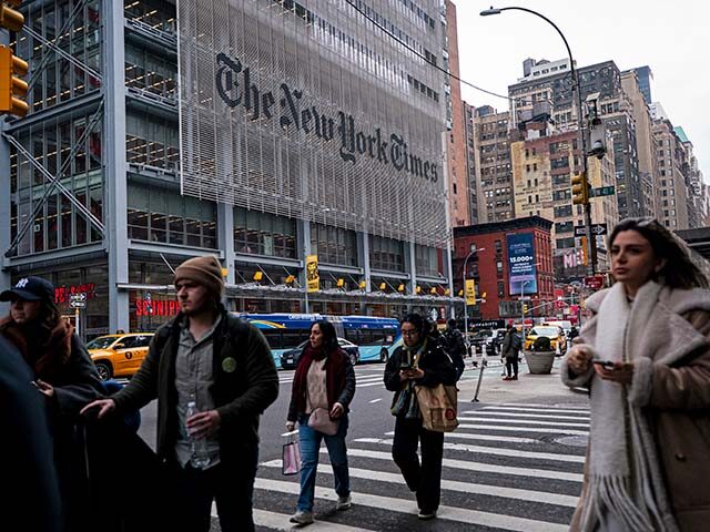 GettyImages2257847301 People walk past The New York Times Building, a 52-story skyscraper on the west side of Mi