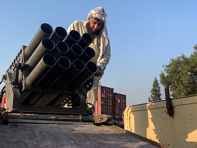 A Taliban security personnel operates a rocket launcher near the Torkham border crossing b