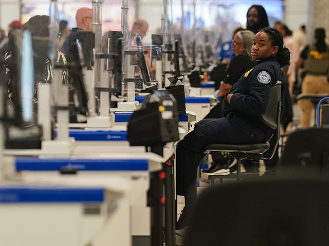 A Transportation Security Administration (TSA) agent at a screening checkpoint at Hartsfie
