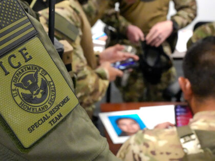 ICE Special Response Team operators attend a pre-operation brief about a wanted criminal i