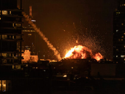 A fireball lights the sky following a missile strike on Tel Aviv on February 28, 2026. The