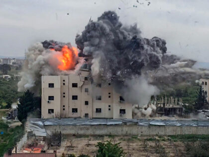 TOPSHOT - A fireball errupts from the site of an Israeli airstrike that targeted a buildin