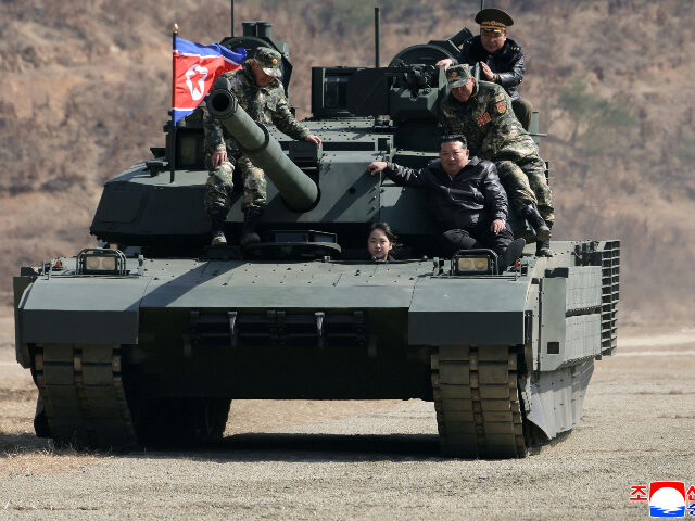 This photo provided by the North Korean government shows its leader Kim Jong Un, front rig
