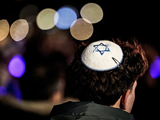 A man wearing a kippa attends the Chanukah celebration in the Zuidas business district, in