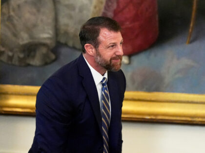 Sen. Markwayne Mullin, R-Okla., stands as President Donald Trump speaks during a signing e